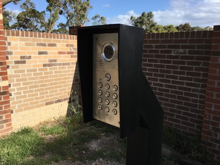 intercom mounted on a post next to gates